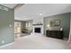 Inviting living room with a charming brick fireplace, neutral carpet and outdoor access at 5400 Kaplan Dr, Raleigh, NC 27606