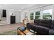 Inviting living room with large windows, modern furniture, and stylish decor, creating a comfortable atmosphere at 5400 Kaplan Dr, Raleigh, NC 27606