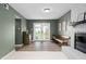 Spacious living room featuring a brick fireplace, with light, neutral, stylish furnishings at 5400 Kaplan Dr, Raleigh, NC 27606