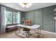 Modern office space with a large window, stylish desk, chair, and custom wall paneling at 5400 Kaplan Dr, Raleigh, NC 27606