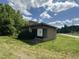 Exterior view of a single-story brick building featuring a flat roof, large windows, and green lawn at 5934 Boston Rd, Roxboro, NC 27574
