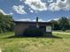 Front exterior view of a brick building on a sunny day showing the flat roof, windows, and lawn at 5934 Boston Rd, Roxboro, NC 27574