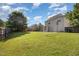 Large backyard with a soccer net, basketball hoop, fenced yard, and mature trees at 605 Bellefont Ct, Knightdale, NC 27545