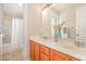 Bright bathroom with a double vanity, wood cabinets, and a shower-tub combination at 605 Bellefont Ct, Knightdale, NC 27545