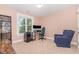 Carpeted bedroom with a desk, bookshelf, and a comfortable armchair by the window at 605 Bellefont Ct, Knightdale, NC 27545