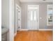 Bright entrance with hardwood floors, white door, and trim at 605 Bellefont Ct, Knightdale, NC 27545