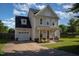 Exterior elevation showcasing a two-story home with a front porch and attached garage at 605 Bellefont Ct, Knightdale, NC 27545