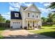 Charming two-story home with a well-manicured lawn, inviting front porch, and attached garage at 605 Bellefont Ct, Knightdale, NC 27545