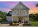 Charming home with a covered front porch, well-manicured lawn, and attached garage at 605 Bellefont Ct, Knightdale, NC 27545