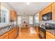 Bright kitchen with wood cabinets open to dining area with hardwood floors at 605 Bellefont Ct, Knightdale, NC 27545