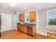 Well-lit kitchen featuring wood cabinets, stainless steel appliances, and hardwood flooring at 605 Bellefont Ct, Knightdale, NC 27545