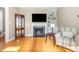 Inviting living room with a fireplace, built-in shelving, and comfortable chair at 605 Bellefont Ct, Knightdale, NC 27545