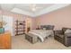 Spacious bedroom with tray ceilings, carpeted floors, and access to the bathroom at 605 Bellefont Ct, Knightdale, NC 27545