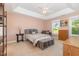 Spacious bedroom with tray ceilings, carpeted floors, and many windows at 605 Bellefont Ct, Knightdale, NC 27545