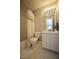 Cozy bathroom features a tub with shower, single sink vanity and neutral color palette at 6229 Saybrooke Dr, Raleigh, NC 27604