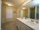 Bathroom featuring double sinks, large mirror, and natural light at 6229 Saybrooke Dr, Raleigh, NC 27604