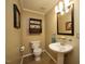 Cozy bathroom features toilet, pedestal sink, towel bar, lighting, and decor at 6229 Saybrooke Dr, Raleigh, NC 27604