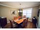 Dining room features a window and chandelier over the wood table with seating for six at 6229 Saybrooke Dr, Raleigh, NC 27604