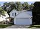 Traditional two-story home with attached two car garage, manicured lawn and mature trees at 6229 Saybrooke Dr, Raleigh, NC 27604
