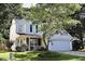 Charming two-story home with white siding, attached garage, and well-manicured lawn at 6229 Saybrooke Dr, Raleigh, NC 27604