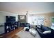 Bright living room with hardwood floors, stone fireplace, and comfortable seating area at 6229 Saybrooke Dr, Raleigh, NC 27604