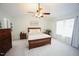 Spacious main bedroom with ceiling fan, two windows, and neutral decor at 6229 Saybrooke Dr, Raleigh, NC 27604