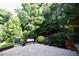 This outdoor patio features stone pavers, a bench, and lush landscaping at 6229 Saybrooke Dr, Raleigh, NC 27604