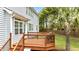 View of the deck with a grill and outdoor seating overlooking a lush yard with mature trees at 626 Toledo Ct, Rolesville, NC 27571