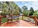 Relaxing deck with seating overlooking the backyard pool and shed, surrounded by lush greenery and mature trees at 626 Toledo Ct, Rolesville, NC 27571