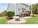 Backyard featuring a patio with a fire pit, outdoor seating, a deck, and lush landscaping at 626 Toledo Ct, Rolesville, NC 27571