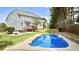 Inviting backyard featuring a sparkling in-ground pool, patio with fire pit, deck, and lush landscaping at 626 Toledo Ct, Rolesville, NC 27571