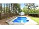 Backyard featuring a sparkling in-ground pool, a storage shed, and lush landscaping, perfect for relaxation and entertainment at 626 Toledo Ct, Rolesville, NC 27571