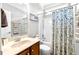 Bathroom with wood vanity and shower featuring a blue patterned curtain at 626 Toledo Ct, Rolesville, NC 27571