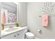 Well-lit bathroom with a vanity sink, toilet, and decorative accents at 626 Toledo Ct, Rolesville, NC 27571