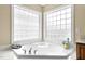 Corner bathtub with glass block window for privacy at 626 Toledo Ct, Rolesville, NC 27571
