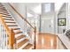 Bright foyer features hardwood floors, white trim, and staircase with natural wood treads at 626 Toledo Ct, Rolesville, NC 27571