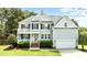 Charming two-story home with a welcoming entrance, well-manicured lawn, and a spacious two-car garage at 626 Toledo Ct, Rolesville, NC 27571