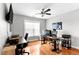Functional home office with dual desks, ceiling fan, and hardwood floors at 626 Toledo Ct, Rolesville, NC 27571