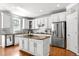 Modern kitchen features white cabinets, stainless steel appliances, and a center island at 626 Toledo Ct, Rolesville, NC 27571