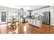 Modern kitchen features white cabinets, stainless steel appliances, and an island at 626 Toledo Ct, Rolesville, NC 27571