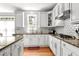 Well-lit kitchen with granite countertops, white cabinetry, stainless steel appliances, and subway tile backsplash at 626 Toledo Ct, Rolesville, NC 27571