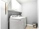 Functional laundry room with washer, dryer, and storage cabinets at 626 Toledo Ct, Rolesville, NC 27571