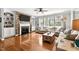 Spacious living room with brick fireplace, large windows, and hardwood floors at 626 Toledo Ct, Rolesville, NC 27571