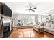 Cozy living room with brick fireplace, large windows, and hardwood floors at 626 Toledo Ct, Rolesville, NC 27571