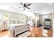 Spacious bedroom with hardwood floors, a ceiling fan, and access to a home gym at 626 Toledo Ct, Rolesville, NC 27571