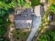 Aerial view of a charming home with a well-maintained roof, driveway, and lush greenery surrounding the property at 698 Maple Springs Ln, Bear Creek, NC 27207