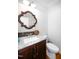 Well lit bathroom features a granite-topped vanity with modern fixtures and a nearby toilet at 698 Maple Springs Ln, Bear Creek, NC 27207