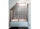 Detailed tub and shower with a glass screen and decorative tile surround in a modern style at 698 Maple Springs Ln, Bear Creek, NC 27207