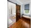 Bathroom with wood floors and a rustic sliding door at 698 Maple Springs Ln, Bear Creek, NC 27207