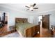 Bedroom with hardwood floors, fan, and rustic sliding door leading to bathroom at 698 Maple Springs Ln, Bear Creek, NC 27207